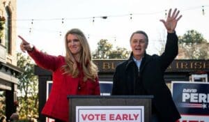© Al Drago/Reuters Senators Kelly Loeffler (R., Ga.) and David Perdue (R., Ga.), wave during a campaign event in Milton, Ga., December 21, 2020.